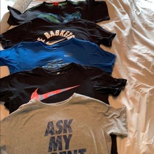 4 Boys size L Nike shirts and 1 M puma shirt